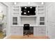 A home office with built-in cabinets and an adjacent tiled bathroom at 5160 Pratt Sw St, Covington, GA 30014