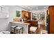Cozy kitchen with wood cabinets, granite counters, and stainless-steel appliances opening to the living room at 5160 Pratt Sw St, Covington, GA 30014