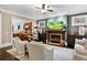 Cozy living room with fireplace, comfortable seating, and open access to the kitchen at 5160 Pratt Sw St, Covington, GA 30014