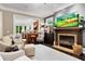 Cozy living room with fireplace, comfortable seating, and open access to the kitchen at 5160 Pratt Sw St, Covington, GA 30014