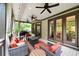 Relaxing covered patio with a grill and outdoor seating with ceiling fans and views of the landscaped backyard at 5160 Pratt Sw St, Covington, GA 30014