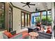 Inviting outdoor patio with comfortable seating, ceiling fans, and elegant drapery at 5160 Pratt Sw St, Covington, GA 30014