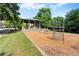 Community playground with swings, a climbing structure, and a covered pavilion at 5160 Pratt Sw St, Covington, GA 30014