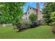 Expansive backyard showcasing mature trees, landscaping, and a deck, offering a serene and private outdoor retreat at 5435 Vicarage Walk, Alpharetta, GA 30005