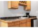 A convenient bar area with marble counters, sink, wine rack and mini fridge at 5435 Vicarage Walk, Alpharetta, GA 30005