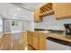 Features a wet bar with a marble countertop, wooden cabinets, and an adjacent living space at 5435 Vicarage Walk, Alpharetta, GA 30005