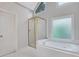 Bright bathroom featuring a separate shower and tub beneath a triangular window at 5435 Vicarage Walk, Alpharetta, GA 30005