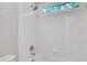 Clean bathroom with white tile shower and a window for natural light at 5435 Vicarage Walk, Alpharetta, GA 30005