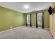 Spacious bedroom with green walls and ample natural light from two windows at 5435 Vicarage Walk, Alpharetta, GA 30005