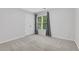 Light-filled bedroom featuring carpeted floors, and a window at 5435 Vicarage Walk, Alpharetta, GA 30005