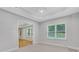 This bedroom has neutral carpet and is adjacent to another room and receives natural light from the window at 5435 Vicarage Walk, Alpharetta, GA 30005