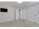 Well-lit bedroom includes a TV and closet for storage at 5435 Vicarage Walk, Alpharetta, GA 30005