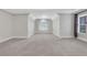 Bright, carpeted bedroom with a tray ceiling and symmetrical design at 5435 Vicarage Walk, Alpharetta, GA 30005