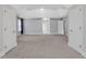 Expansive bedroom with multiple doorways, tray ceiling, and neutral carpet at 5435 Vicarage Walk, Alpharetta, GA 30005