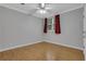 Bedroom with hardwood floors, a window with curtains, and soft gray walls at 5435 Vicarage Walk, Alpharetta, GA 30005
