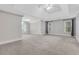 Spacious bedroom with tray ceiling, plush carpet, and natural light from multiple windows at 5435 Vicarage Walk, Alpharetta, GA 30005