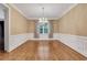 Formal dining room with hardwood floors, classic moldings, and an elegant chandelier fixture at 5435 Vicarage Walk, Alpharetta, GA 30005
