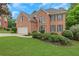 Attractive brick home with a well-maintained lawn and mature landscaping, perfect curb appeal at 5435 Vicarage Walk, Alpharetta, GA 30005