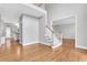 Spacious home foyer with hardwood floors, staircase, and natural light showcasing a welcoming atmosphere at 5435 Vicarage Walk, Alpharetta, GA 30005