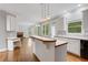 Open kitchen featuring bar-style island and seamless access to adjacent living room at 5435 Vicarage Walk, Alpharetta, GA 30005