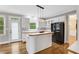 View of the kitchen with island bar, pendant lighting, and stainless steel appliances at 5435 Vicarage Walk, Alpharetta, GA 30005