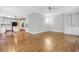 Hardwood floors connect the living room to the kitchen with white cabinets and black appliances at 5435 Vicarage Walk, Alpharetta, GA 30005