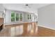 Open-concept living room with hardwood floors, fireplace, and view of adjacent kitchen at 5435 Vicarage Walk, Alpharetta, GA 30005