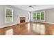 Spacious living room with a brick fireplace and lots of natural light through many windows at 5435 Vicarage Walk, Alpharetta, GA 30005
