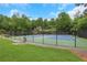 Well-maintained community tennis court with pristine blue and green surface, surrounded by lush greenery and secure fencing at 5435 Vicarage Walk, Alpharetta, GA 30005