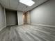 View of basement with closet and door, light gray walls and gray wood floor at 990 Azalea Dr, Roswell, GA 30075