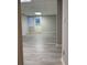 View of basement with white door to backyard, gray wood floor, and neutral paint at 990 Azalea Dr, Roswell, GA 30075