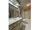 Clean bathroom with a marble vanity, decorative mirror, and white tile floors at 990 Azalea Dr, Roswell, GA 30075