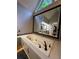 Bright bathroom featuring a soaking tub with black fixtures under a large mirror at 990 Azalea Dr, Roswell, GA 30075
