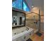 Modern bathroom featuring glass enclosed shower, soaking tub, and large triangle window at 990 Azalea Dr, Roswell, GA 30075
