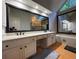 Modern bathroom featuring double sinks, soaking tub, large window, and glass shower at 990 Azalea Dr, Roswell, GA 30075