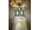 Spacious bedroom featuring tray ceilings, a ceiling fan, and two windows allowing ample natural light at 990 Azalea Dr, Roswell, GA 30075