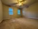 Carpeted bedroom with ceiling fan and two windows providing natural light at 990 Azalea Dr, Roswell, GA 30075