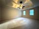 Spacious bedroom featuring tray ceilings, a ceiling fan, and two windows allowing ample natural light at 990 Azalea Dr, Roswell, GA 30075
