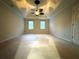 Large carpeted bedroom featuring a modern ceiling fan and two sunny windows at 990 Azalea Dr, Roswell, GA 30075