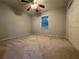 Carpeted bedroom with a ceiling fan, closet, and natural light from the window at 990 Azalea Dr, Roswell, GA 30075