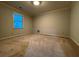 Spacious empty bedroom with carpeted floor, large window, and neutral wall color at 990 Azalea Dr, Roswell, GA 30075