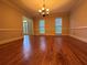 Spacious dining room with gleaming hardwood floors, neutral walls, and abundant natural light from the windows at 990 Azalea Dr, Roswell, GA 30075