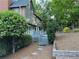 Back of house showing a gray deck and gray siding and brick chimney surrounded by trees and bushes at 990 Azalea Dr, Roswell, GA 30075
