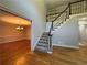 Bright foyer featuring hardwood floors, a staircase with black railings, and views into a dining area at 990 Azalea Dr, Roswell, GA 30075