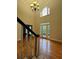 Two-story foyer featuring hardwood floors, chandelier, and decorative windows at 990 Azalea Dr, Roswell, GA 30075