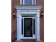 Close up of a front door with decorative glass, sconces, and white trim at 990 Azalea Dr, Roswell, GA 30075