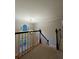 Upstairs hallway featuring a carpeted floor and spindled railing at 990 Azalea Dr, Roswell, GA 30075