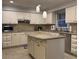 Well-equipped kitchen featuring white cabinets, granite countertops, and a central island at 990 Azalea Dr, Roswell, GA 30075