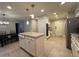 Open kitchen layout with island, tile flooring, and stainless steel appliances at 990 Azalea Dr, Roswell, GA 30075