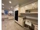 Spacious kitchen featuring light cabinetry, granite countertops, and tile flooring at 990 Azalea Dr, Roswell, GA 30075